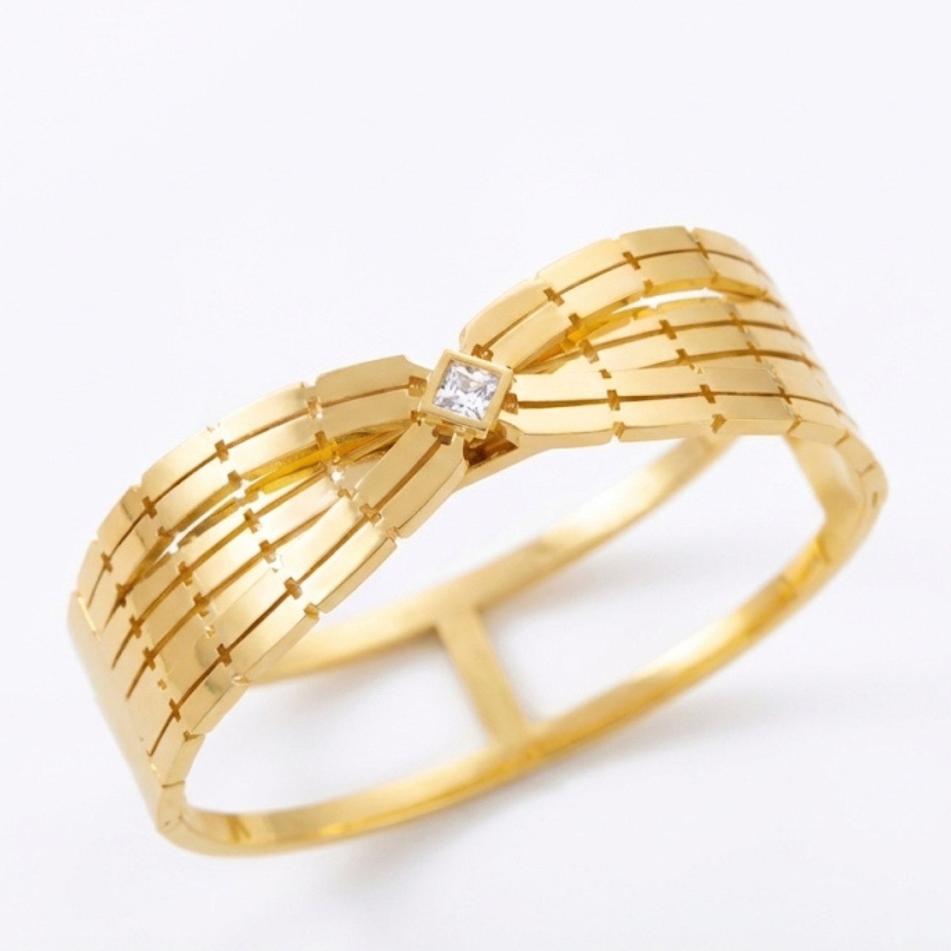 Close up of 18K gold plated open cuff bangle with pave crystal bar accent. Waterproof stainless steel jewelry on white display