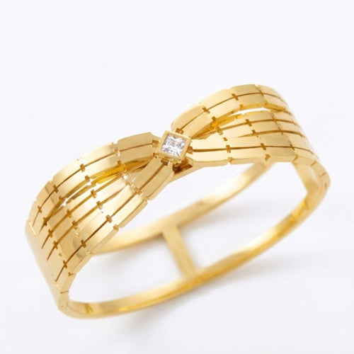 Close up of 18K gold plated open cuff bangle with pave crystal bar accent. Waterproof stainless steel jewelry on white display
