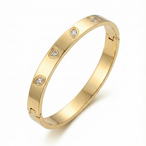 Gold anti-tarnish bangle with crystals on white display.