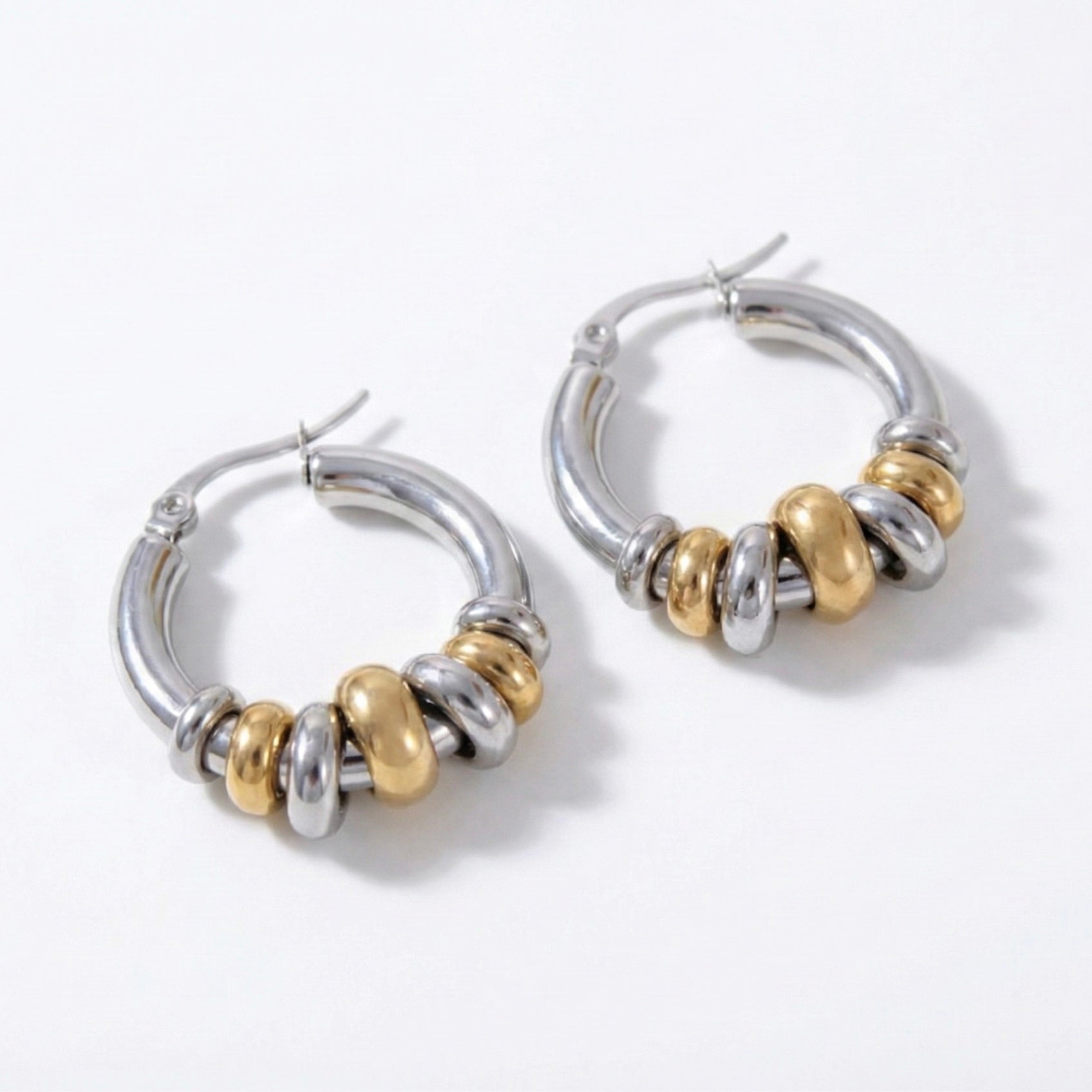 Glow Petal luxury anti-tarnish mixed metal hoop earrings featuring alternating gold and silver rings on a white background