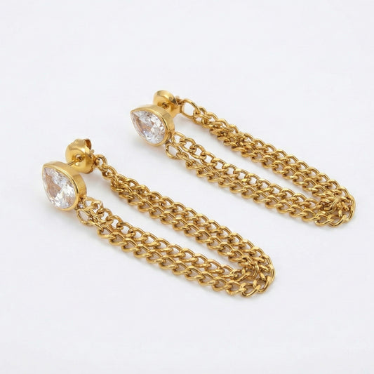 Gold chain earrings with clear gemstones on a white background