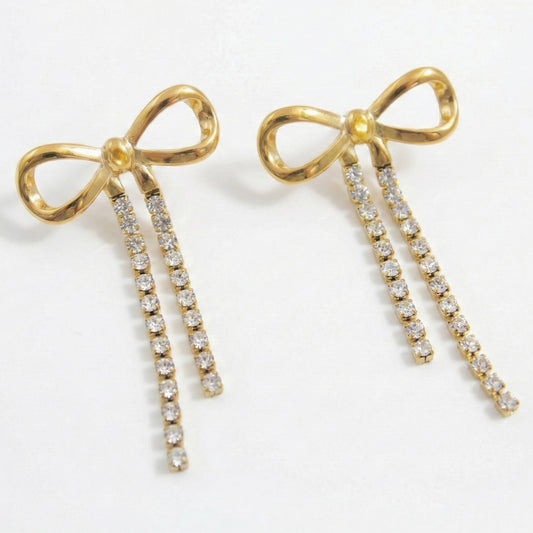 Glow Petal gold bow stud earrings featuring dual strands of dangling crystal rhinestones on a clean white background. Luxury anti-tarnish coquette style jewelry.