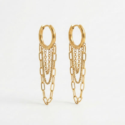 Gold huggie hoop earrings with three dangling chains in paperclip and box textures. 18k gold plated anti-tarnish jewelry by Glow Petal.