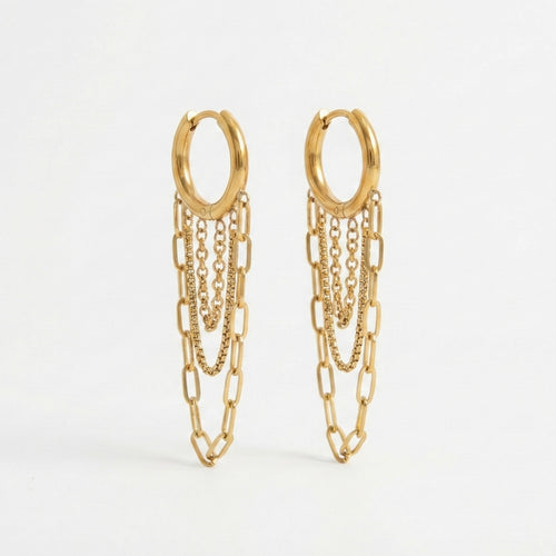 Gold huggie hoop earrings with three dangling chains in paperclip and box textures. 18k gold plated anti-tarnish jewelry by Glow Petal.
