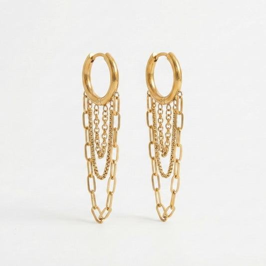 Gold huggie hoop earrings with three dangling chains in paperclip and box textures. 18k gold plated anti-tarnish jewelry by Glow Petal.