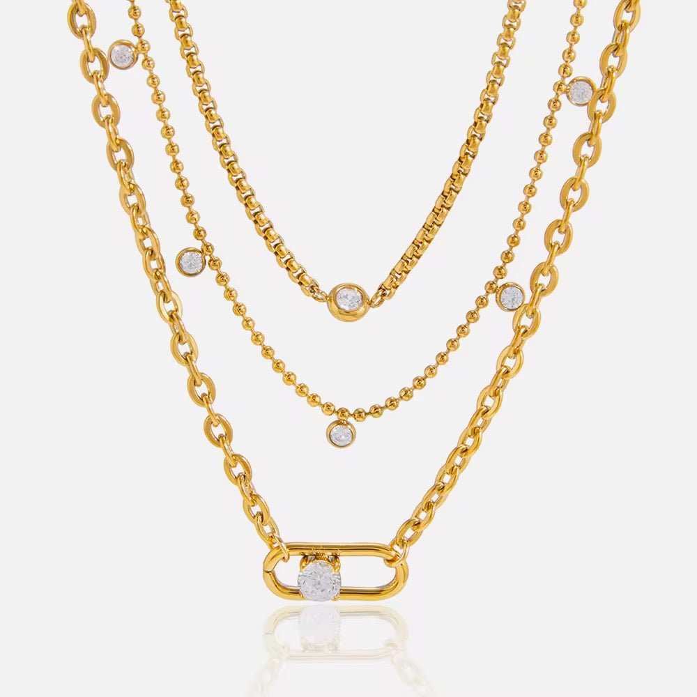 18K gold plated triple layered necklace with cubic zirconia stones on a white background