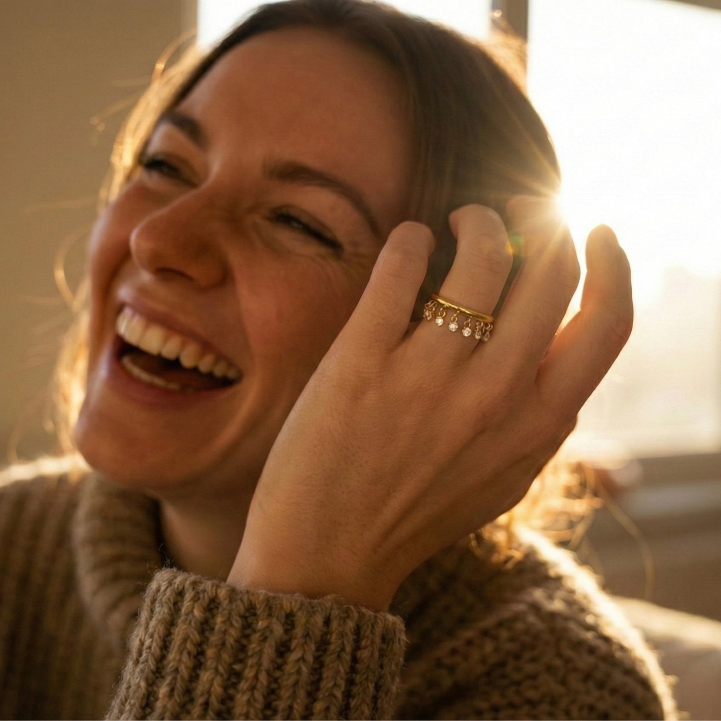 Women wearing Waterproof gold shaker ring with moving cubic zirconia stones.