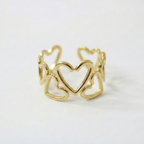 Gold ring with heart design on a white background