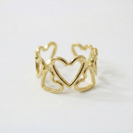 Gold ring with heart design on a white background